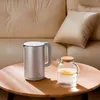 A Xiaomi electric kettle and a glass pitcher with lemon slices are on a round wooden table, with a beige sofa in the background. Náhľad obrázku produktu