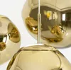 A close-up view of several golden pendant lights. Produktbild-Vorschau