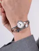A close-up shot of a woman's wrist wearing a silver Guess watch and bracelet. Produktbild-Vorschau