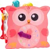 A close-up shot of a pink owl-shaped educational toy with a clock face and colorful accessories. Podgląd zdjęcia produktu