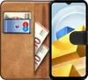 A book-style phone case with slots for cards and cash, shown open with a smartphone inside. Produktbild-Vorschau
