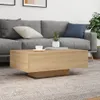A coffee table in front of a sofa in a living room setting. Produktbild-Vorschau