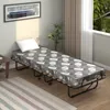 A folding bed with a patterned mattress is set up in a room with a rug and a window. Náhľad obrázku produktu