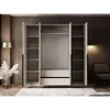 An open wardrobe with shelves and drawers, set in a room with a chair and lamp. Produktbild-Vorschau