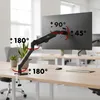 A monitor arm mounted on a desk in an office setting. Anteprima dell’immagine prodotto