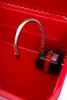 A close-up view of a red workshop washing machine with a flexible metal hose and a black pump. Produktbild-Vorschau