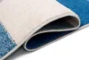 A close-up view of a folded rug, showing the texture and layers of the material. Náhled obrázku produktu