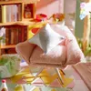 A miniature dollhouse attic scene with a pink chair and a bookshelf. Anteprima dell’immagine prodotto