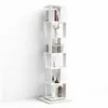 A tall, white, rotating bookshelf with several shelves, each holding decorative items and books, set against a plain white wall. Produktbild-Vorschau