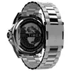 The back of a silver metal watch with a black dial featuring a world map. Voir les images du produit