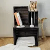 Three wooden crates are stacked and decorated with books, a candle, a small dish, and dried flowers. Produktbild-Vorschau