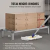 A storage shelf with boxes on it, and a mop on the floor. Voir les images du produit