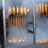 Fish and other food items are being smoked in a smoker. Produktbild-Vorschau