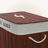 Close-up of a laundry basket with a bamboo lid and fabric sides. Produktbild-Vorschau