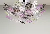 A close-up shot of a decorative ceiling lamp with flower-shaped acrylic elements. Náhled obrázku produktu