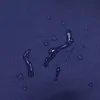 Water droplets on a dark blue fabric surface. Produktbild-Vorschau