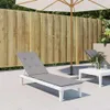 An outdoor patio scene with a lounge chair and umbrella. Produktbild-Vorschau