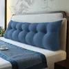 A dark blue wedge pillow is placed on a bed with a blue runner. Produktbild-Vorschau