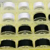 A close-up view of a sewing machine bobbin box filled with spools of thread. Produktbild-Vorschau