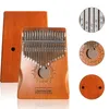 A wooden kalimba instrument with metal tines, shown with its case and some circular diagrams illustrating notes and design. Produktbild-Vorschau