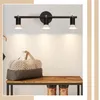 A hallway or entryway scene with a track light fixture, a bench, a duffel bag, and boots. Produktbild-Vorschau