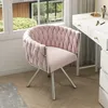 A pink velvet chair with a metal frame is placed next to a white vanity table. Produktbild-Vorschau