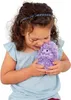 A young girl is holding and hugging a purple plush hedgehog toy. Náhled obrázku produktu