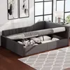 A grey upholstered daybed with storage compartments is shown in a room with large windows and artwork on the wall. Anteprima dell’immagine prodotto