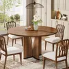 A round wooden dining table with four chairs in a dining room setting. Voir les images du produit