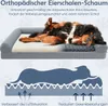 A dog is lying on an orthopedic dog bed, with a diagram below illustrating the bed's features. Voir les images du produit