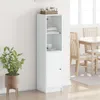 A white highboard with a glass door is shown in a room with a dining table and chairs in the background. Náhľad obrázku produktu
