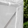 A close-up view of a white greenhouse structure, showing the mesh material and a metal support pole. Produktbild-Vorschau