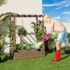 A woman waters plants in a raised garden bed with a trellis structure. Produktbild-Vorschau