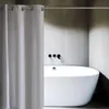 A modern bathroom with a white bathtub and a white shower curtain. Produktbild-Vorschau