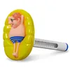 A novelty thermometer with a cartoon man figure relaxing on a yellow inflatable ring. Produktbild-Vorschau
