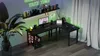 A gaming desk setup in a room with neon lighting and curtains. Produktbild-Vorschau
