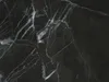 A close-up view of black marble with white veining. Produktbild-Vorschau