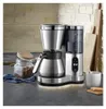 A modern stainless steel filter coffee machine with a thermal carafe and a digital display is shown on a kitchen counter. Voir les images du produit
