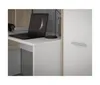 A close-up view of a desk with a laptop and a cabinet door. Produktbild-Vorschau