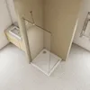 A modern bathroom with a walk-in shower, sink, and vanity. Produktbild-Vorschau