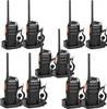 A set of ten black and orange walkie-talkies with their charging docks and headsets, arranged in two rows on a white background. Náhled obrázku produktu
