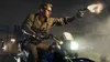 A man riding a motorcycle and firing a gun at night. Produktbild-Vorschau