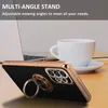 A smartphone case with a ring stand is shown in a lifestyle setting with a laptop and coffee cup in the background. Produktbild-Vorschau