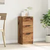A wooden sideboard with three drawers is placed against a white wall, next to a chair and a potted plant. Náhled obrázku produktu