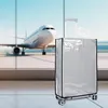 A transparent suitcase cover is shown in front of a large window at an airport, with an airplane visible outside. Anteprima dell’immagine prodotto