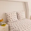 A close-up shot of a bed with floral patterned bedding and pillows. Produktbild-Vorschau