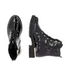Two black patent leather boots with gold accents are shown against a white background. One boot is viewed from the front, and the other is viewed from the side. Produktbild-Vorschau