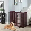 A dog lies on the floor in front of a wooden pet gate installed at the bottom of a staircase. Podgląd zdjęcia produktu