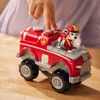 A child's hand is pressing on the top of a red toy fire truck with a dog character inside. Anteprima dell’immagine prodotto
