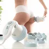 A person is using an anti-cellulite massager on their thigh. Anteprima dell’immagine prodotto